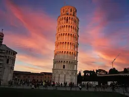 AI image tag example: the Leaning Tower of Pisa at sunset.